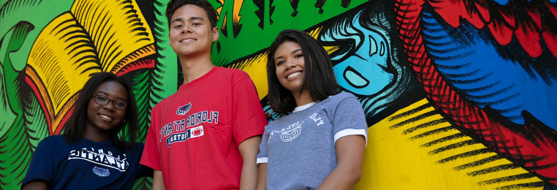 Students standing next to a wall